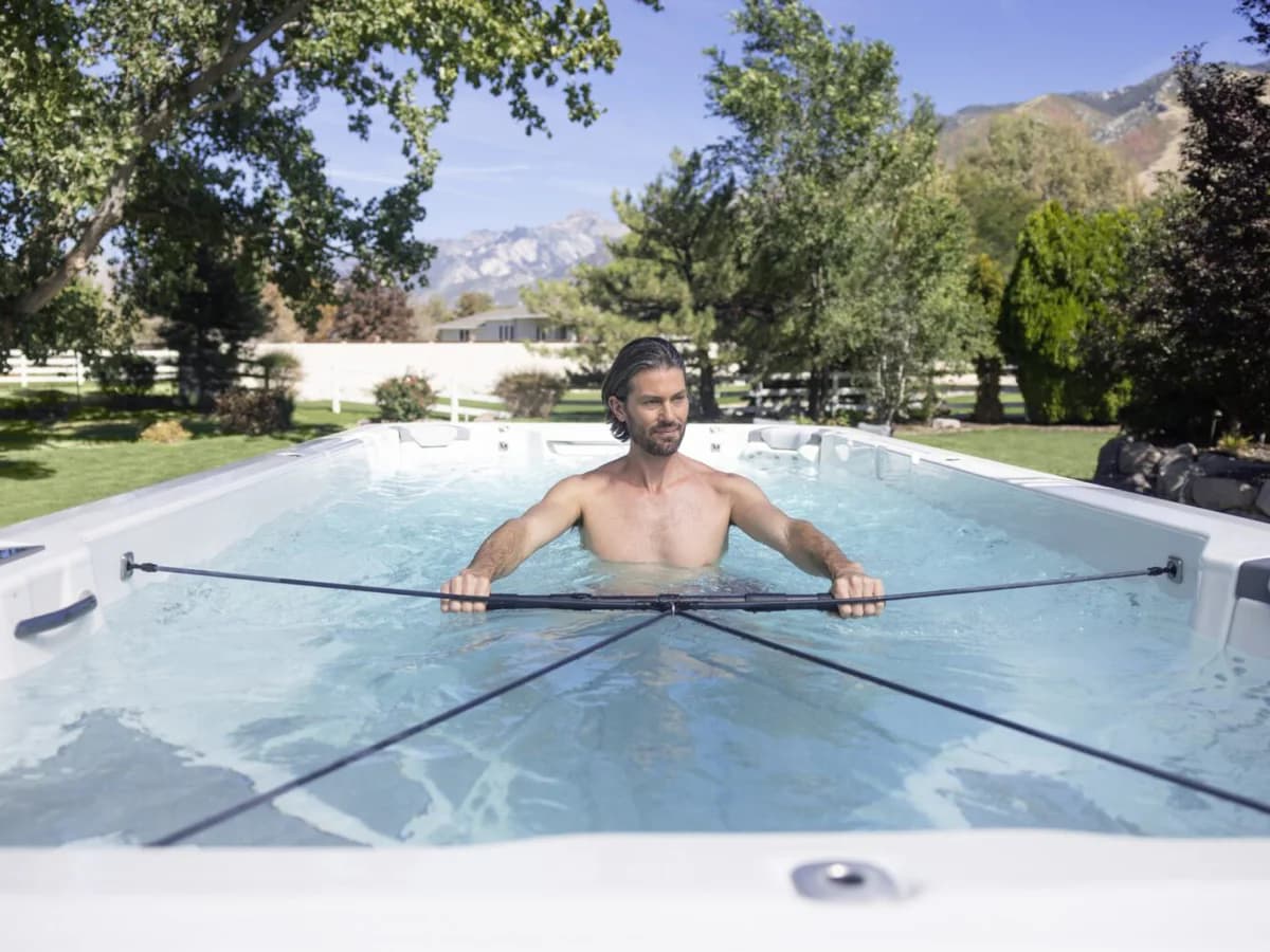 Man completing a guided resistance workout in a Bullfrog Swim Series spa